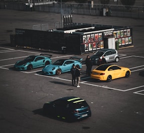 A parking lot with several cars parked in it