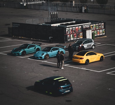 A parking lot with several cars parked in it