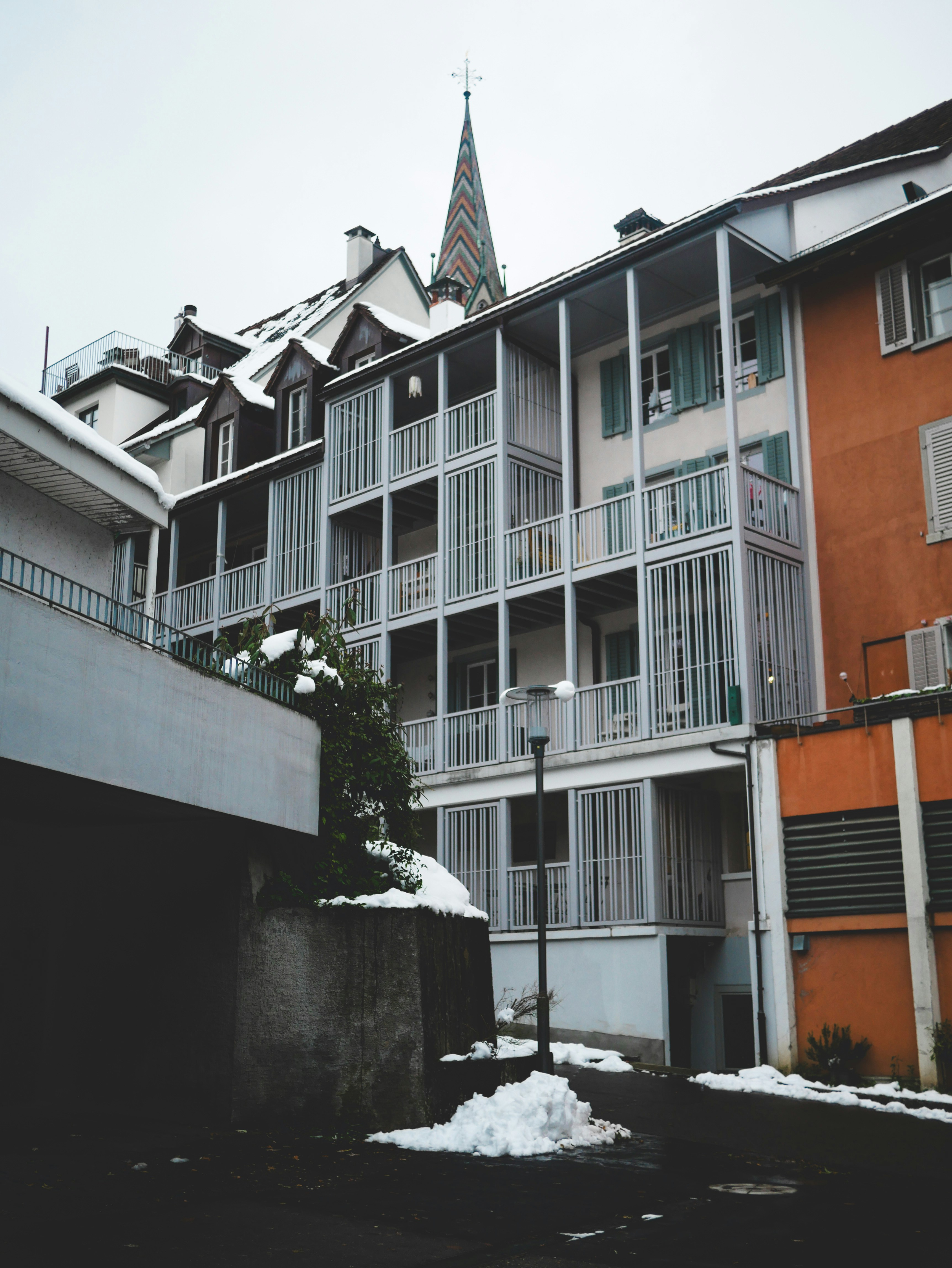An apartment building with a steeple in the background