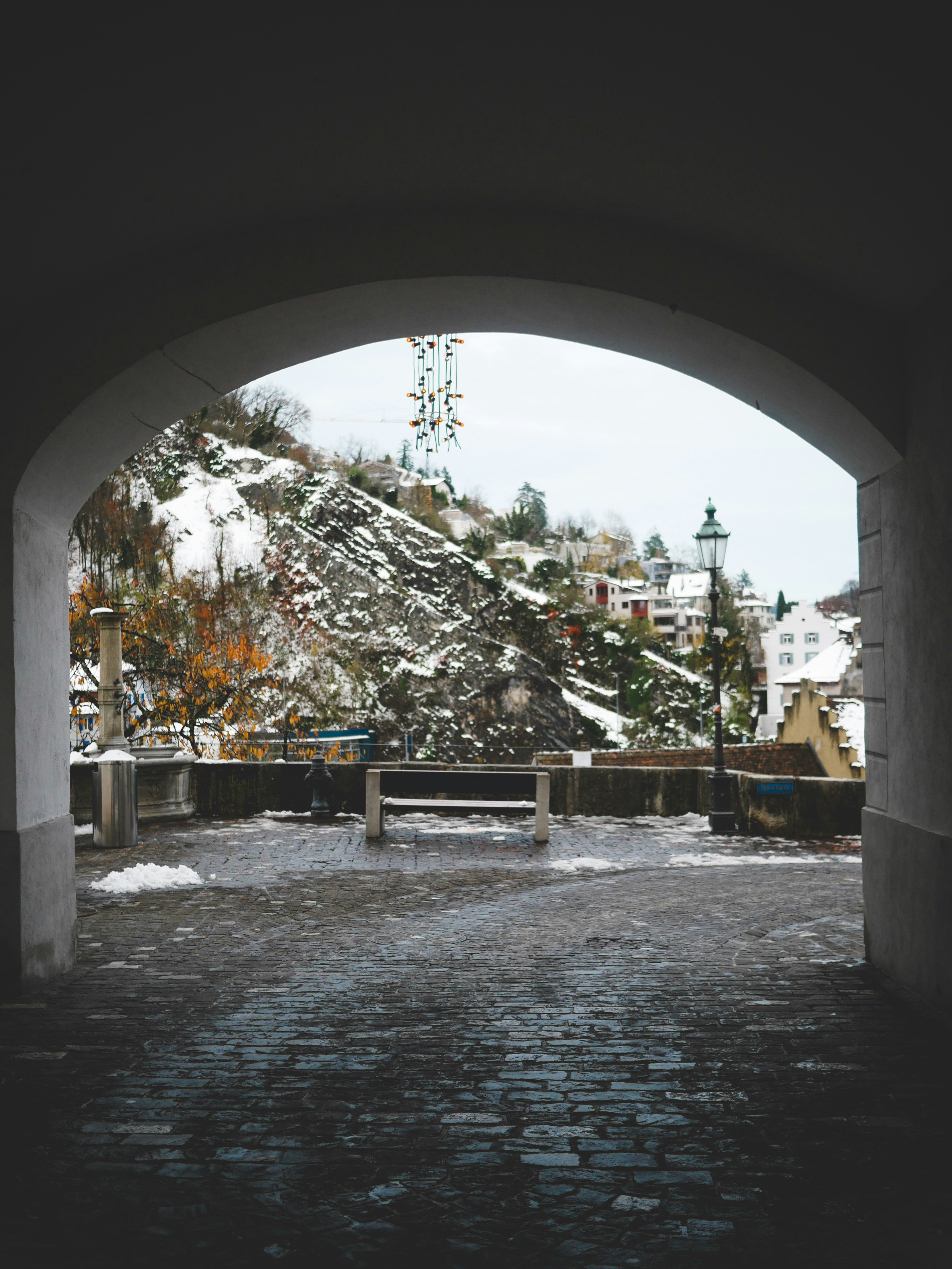 A view of a snow covered mountain through an archway