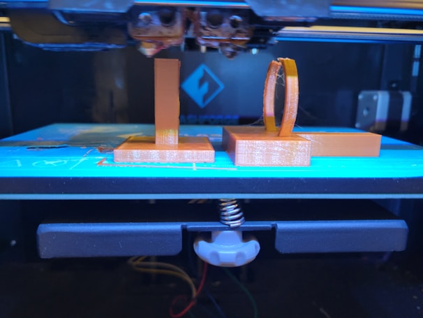 A 3D printer with two boxes attached to it