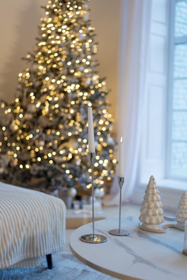 A living room with a christmas tree in the corner