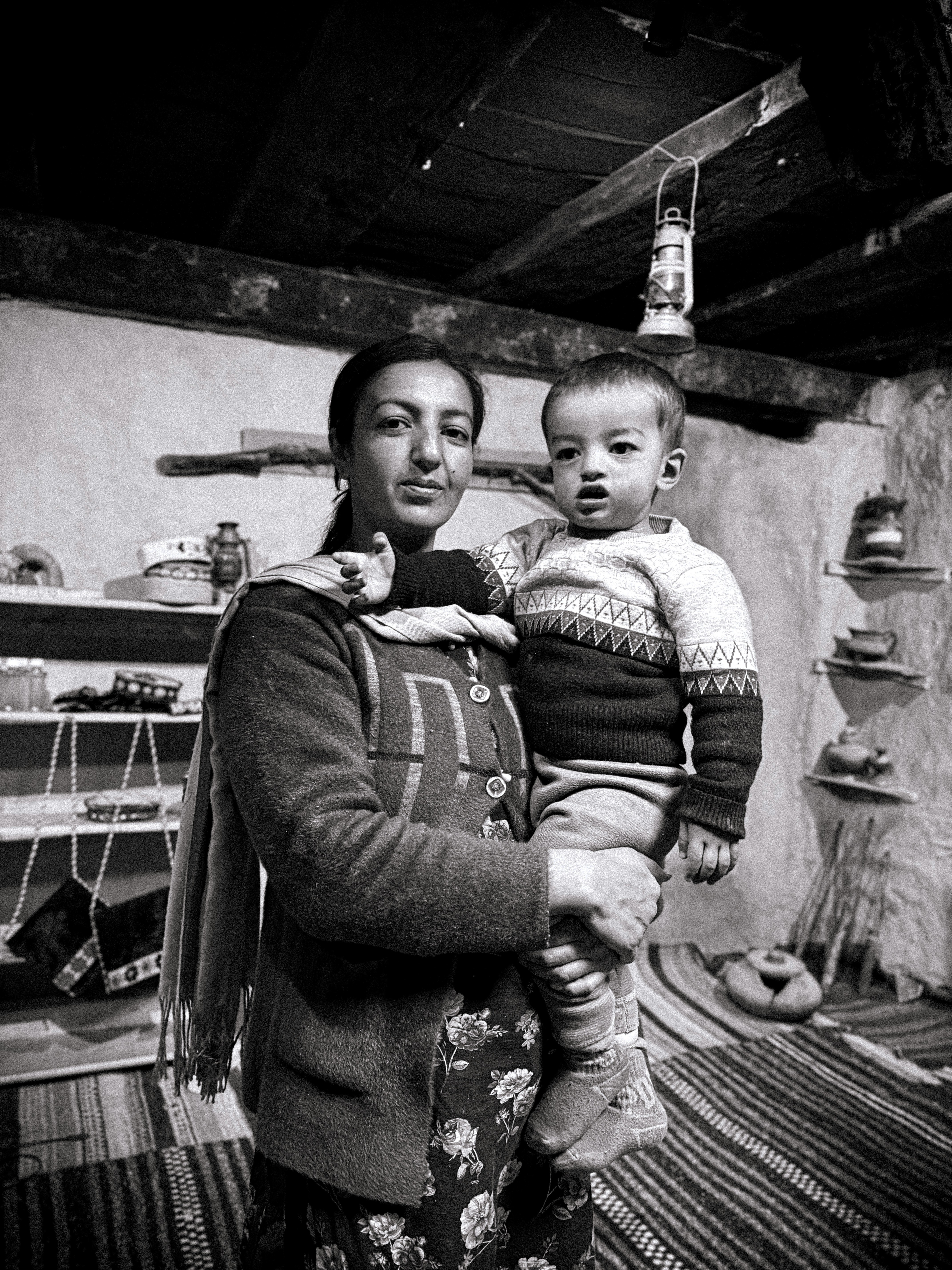 A woman holding a baby in her arms