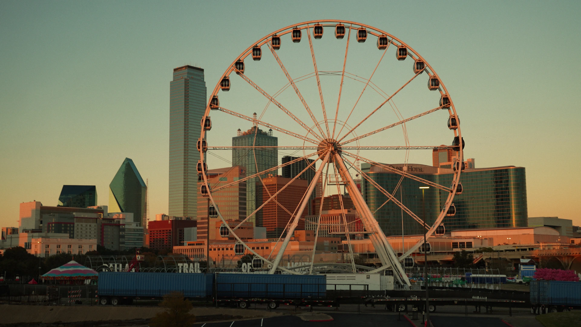 A ferris wheel in front of a city skyline