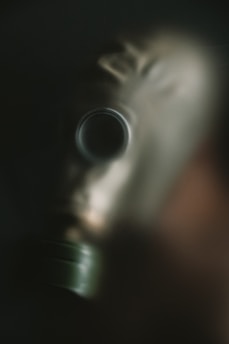 A man wearing a gas mask in the dark