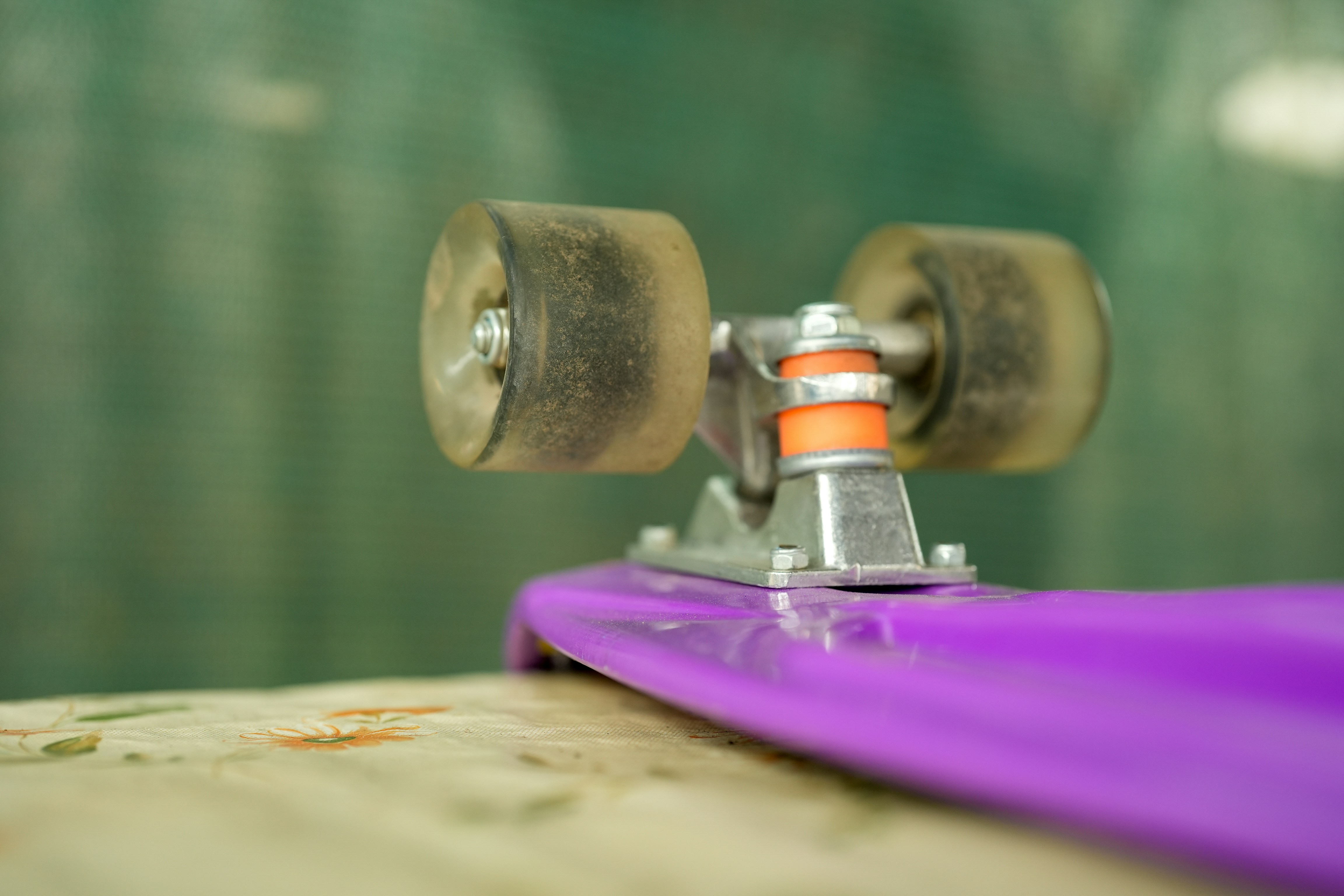 A close up of a skateboard on a wooden surface