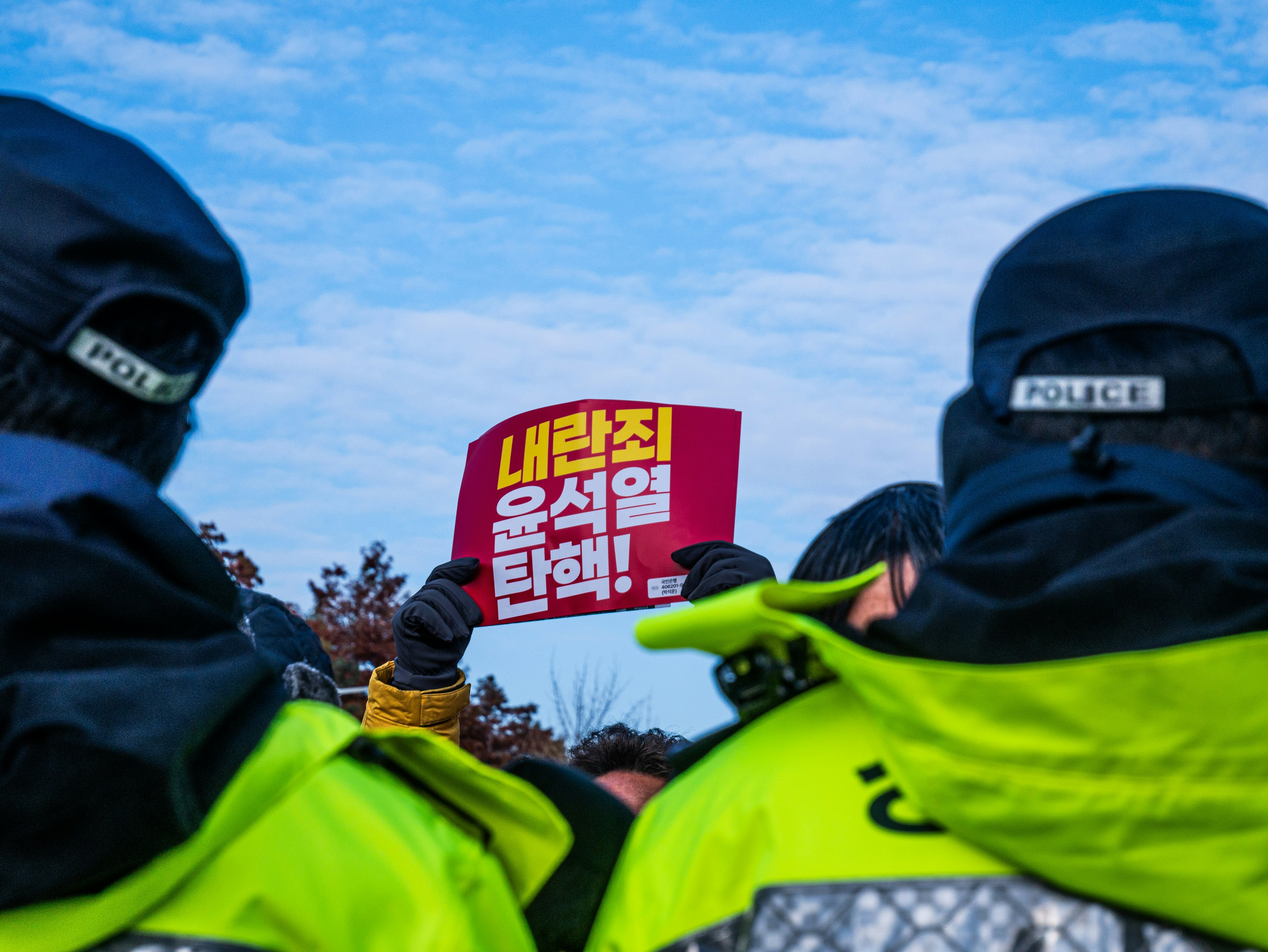 A group of police officers holding a protest sign