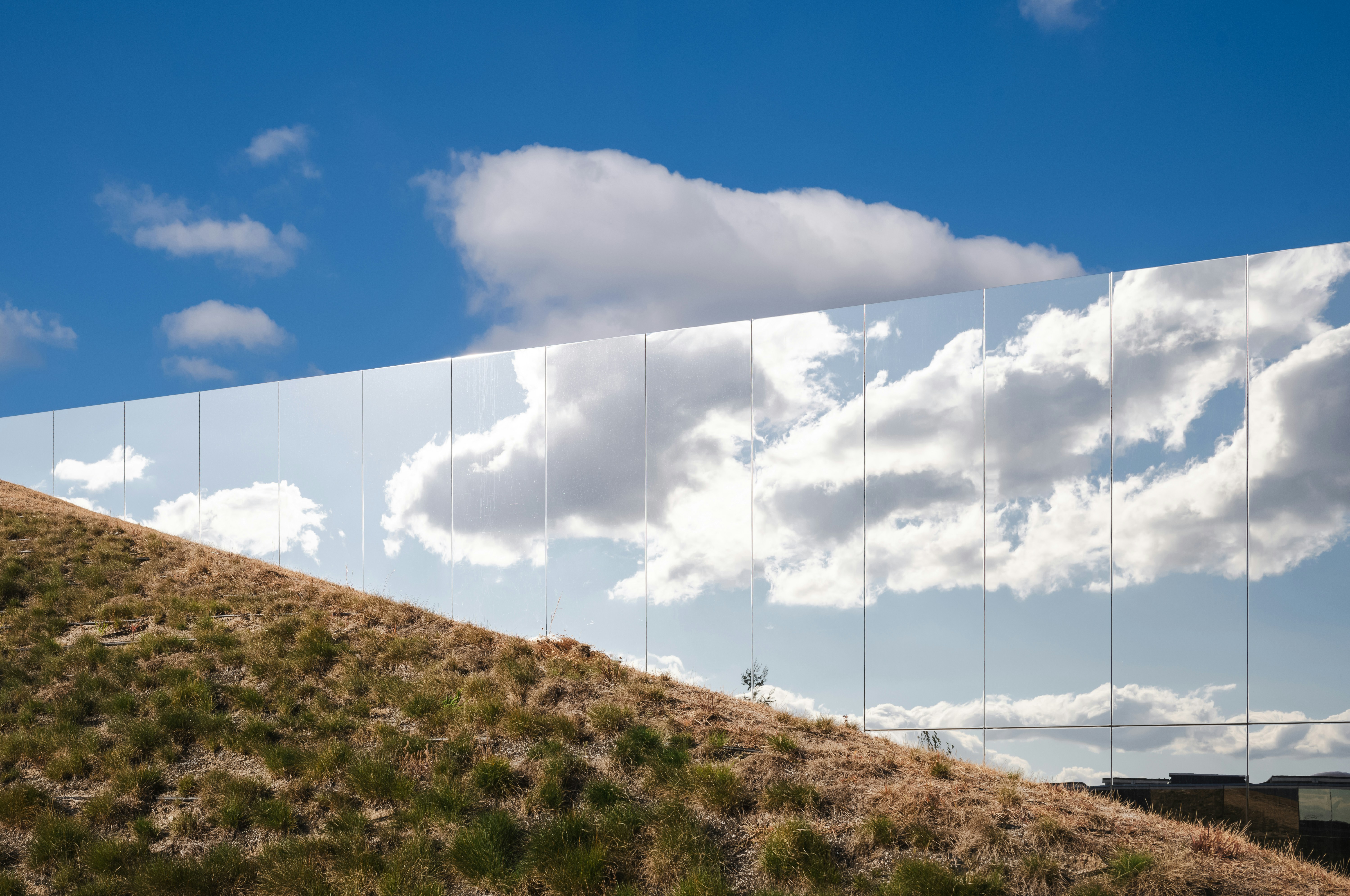 A reflection of a sky and clouds in a mirror