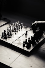 A person playing a game of chess on a table