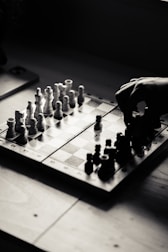 A person playing a game of chess on a table