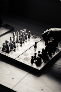 A person playing a game of chess on a table