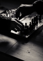 A person playing a game of chess on a table