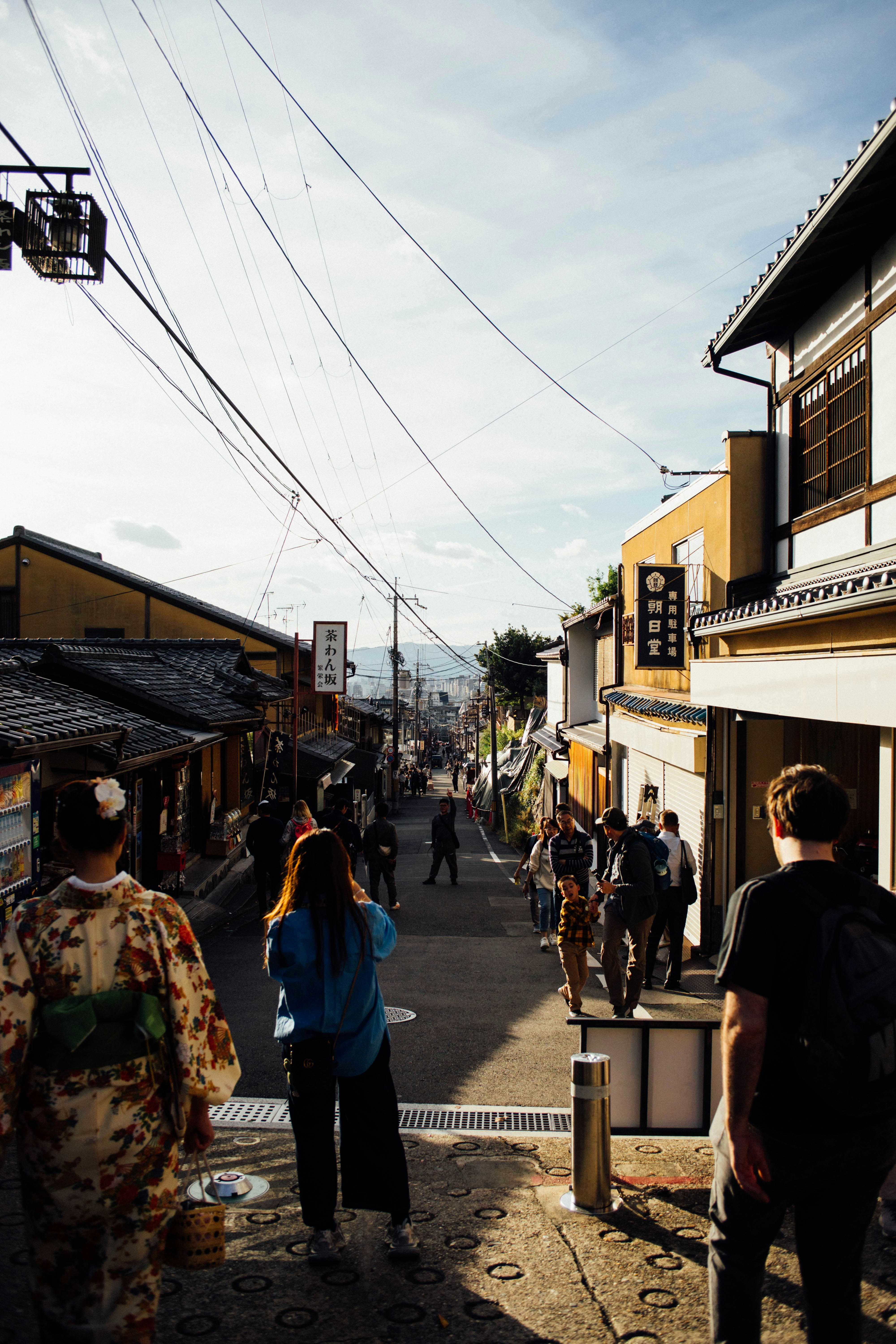 A group of people walking down a street