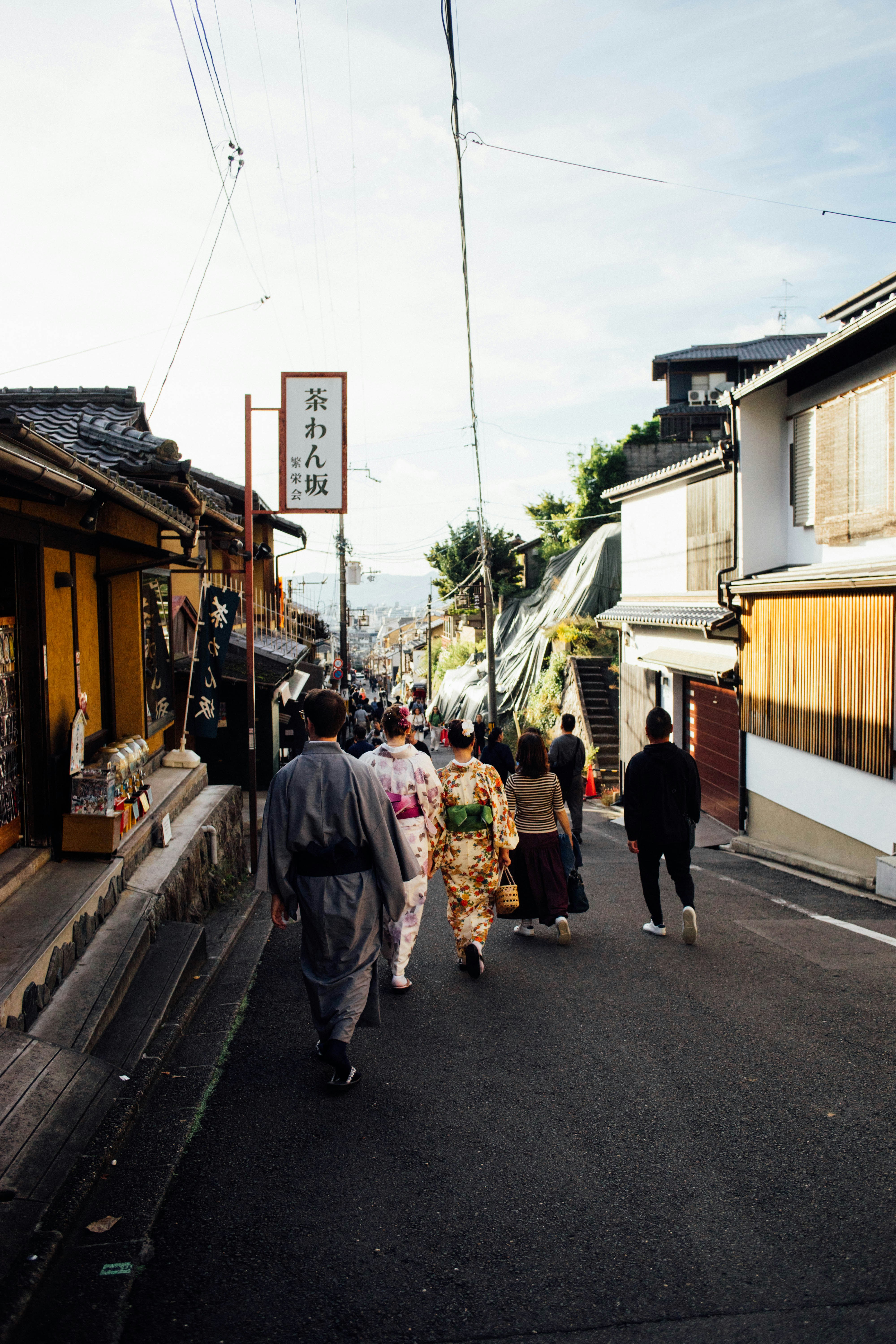 A group of people walking down a street