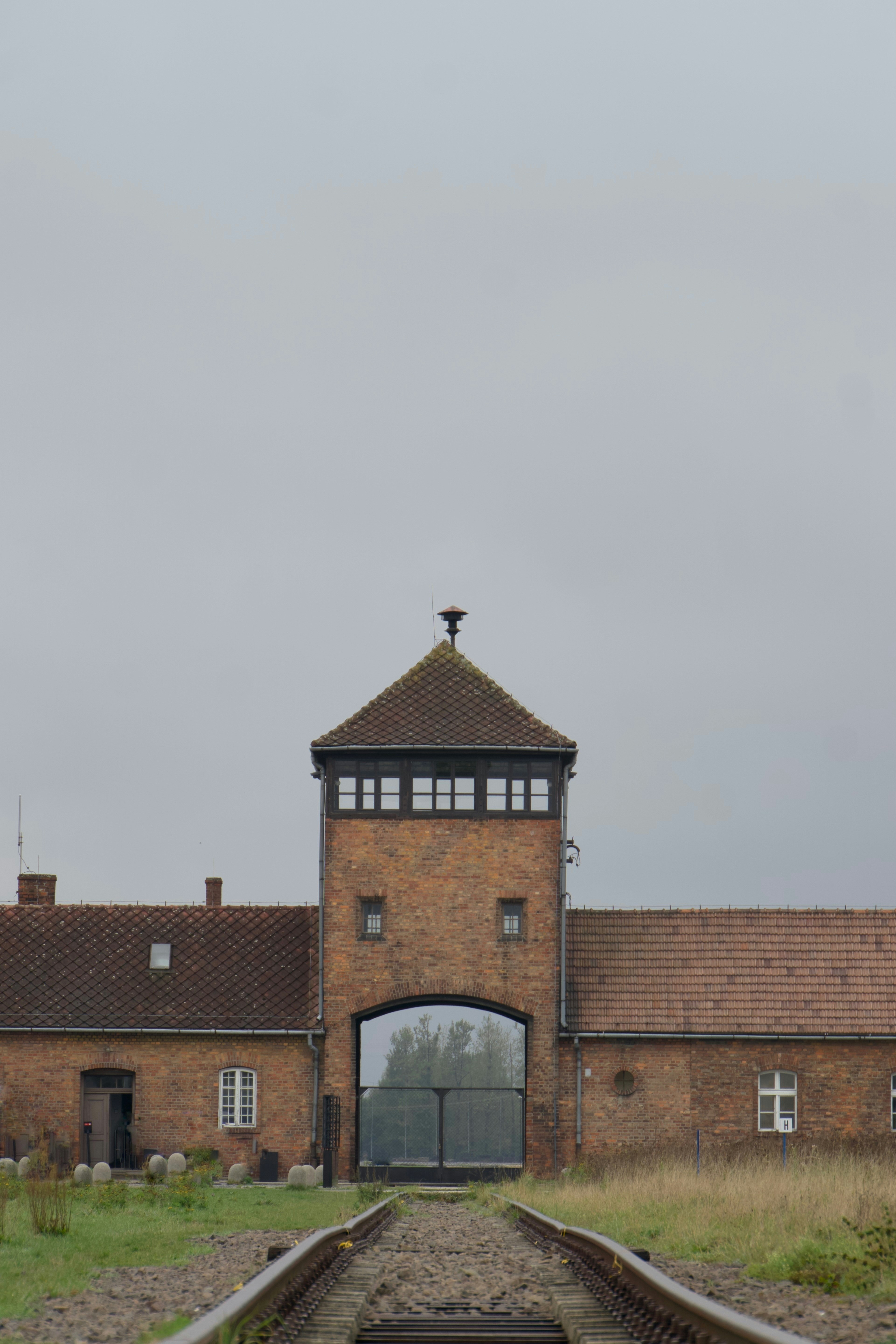 A train track in front of a brick building
