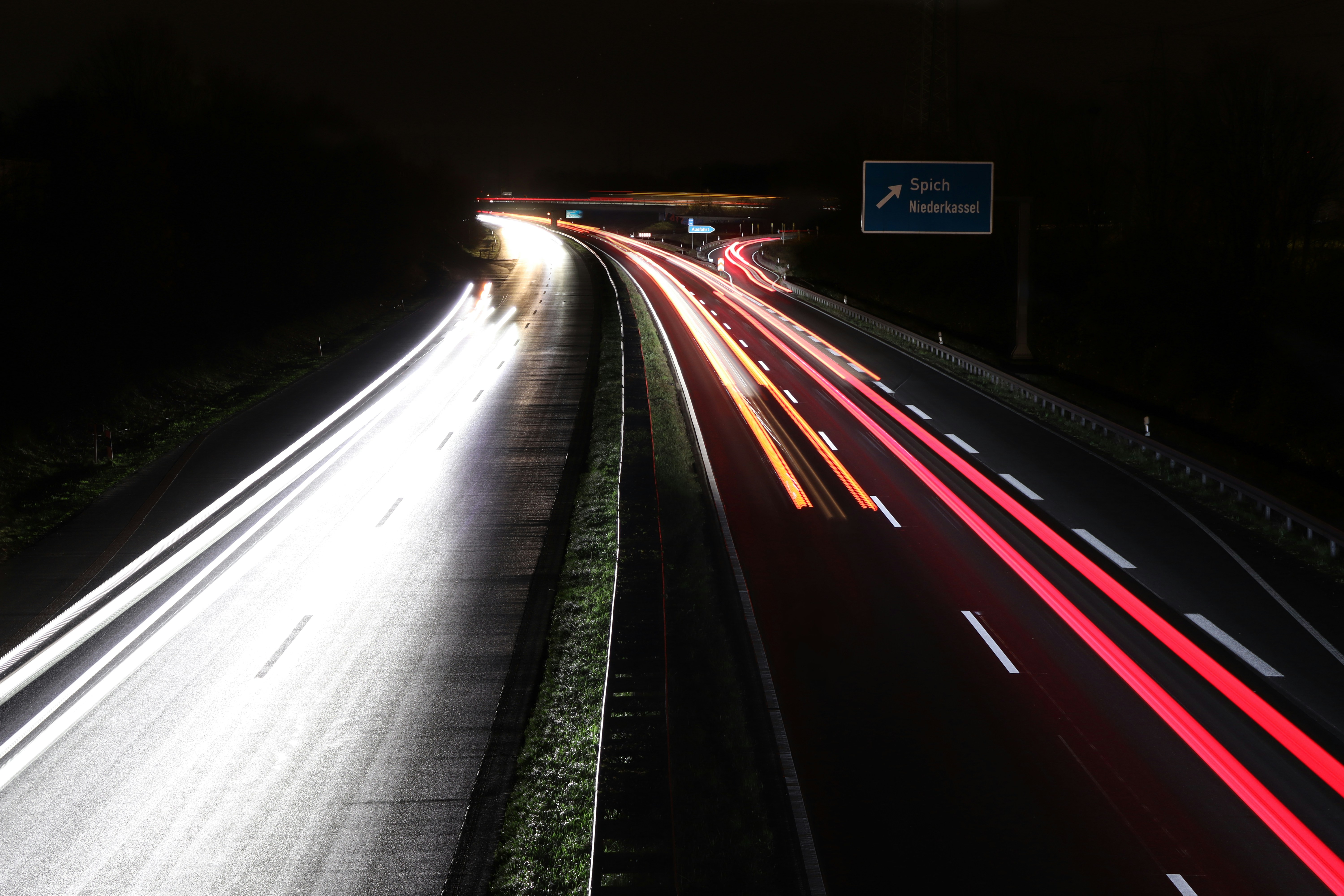A long exposure photo of a highway at night