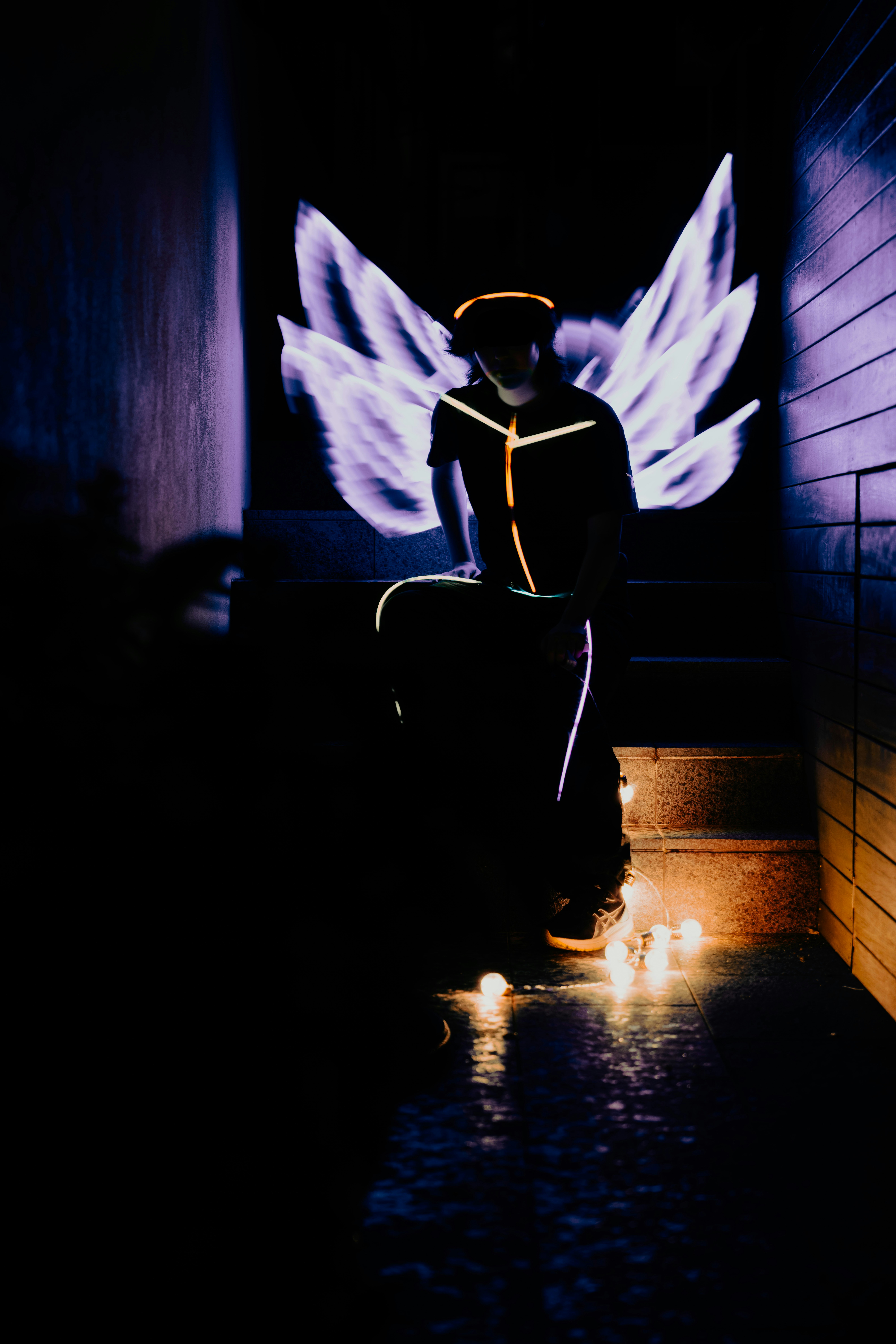 A person sitting on a bench in a dark room