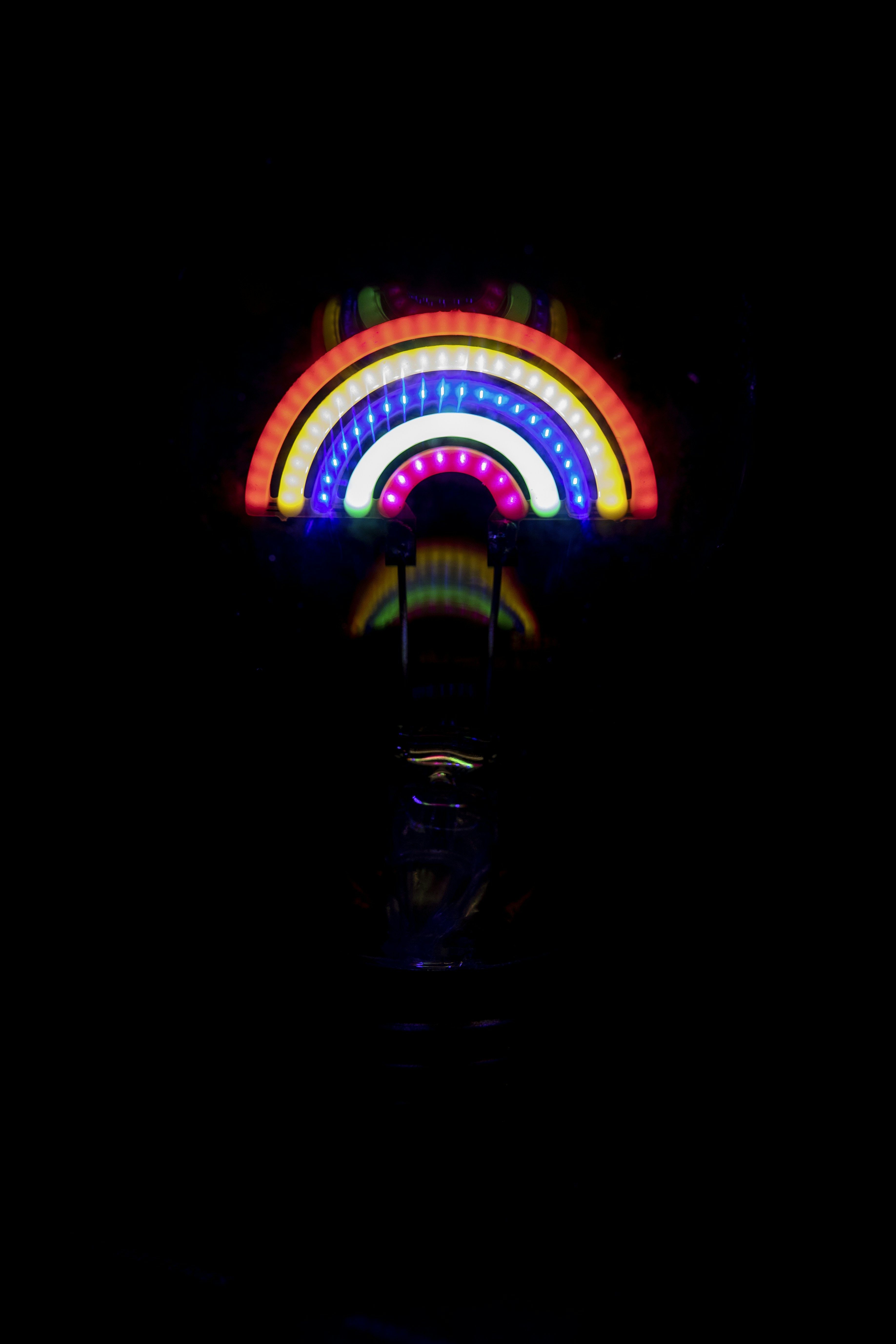 A carnival wheel lit up in the dark