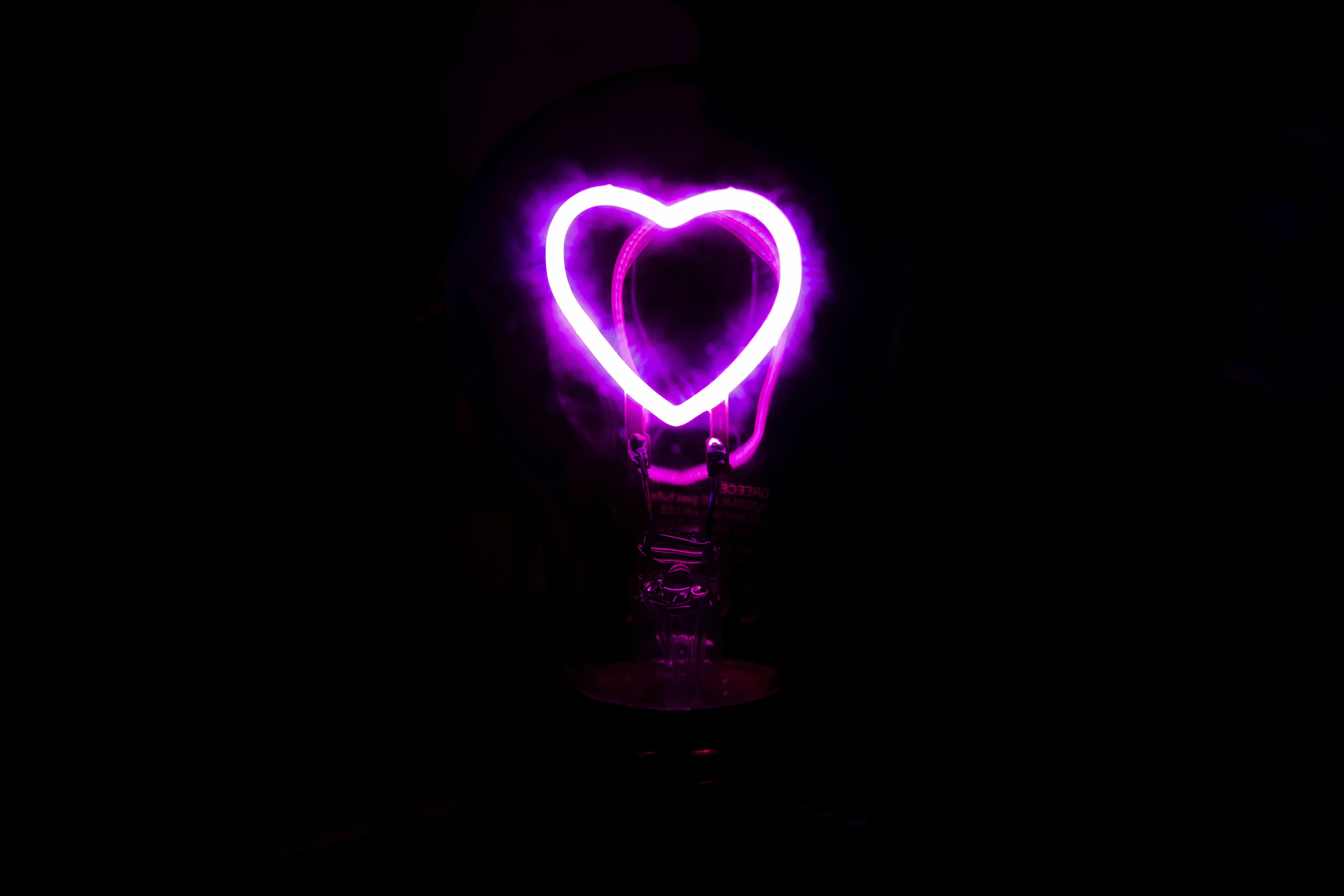 A pink heart shaped light in the dark