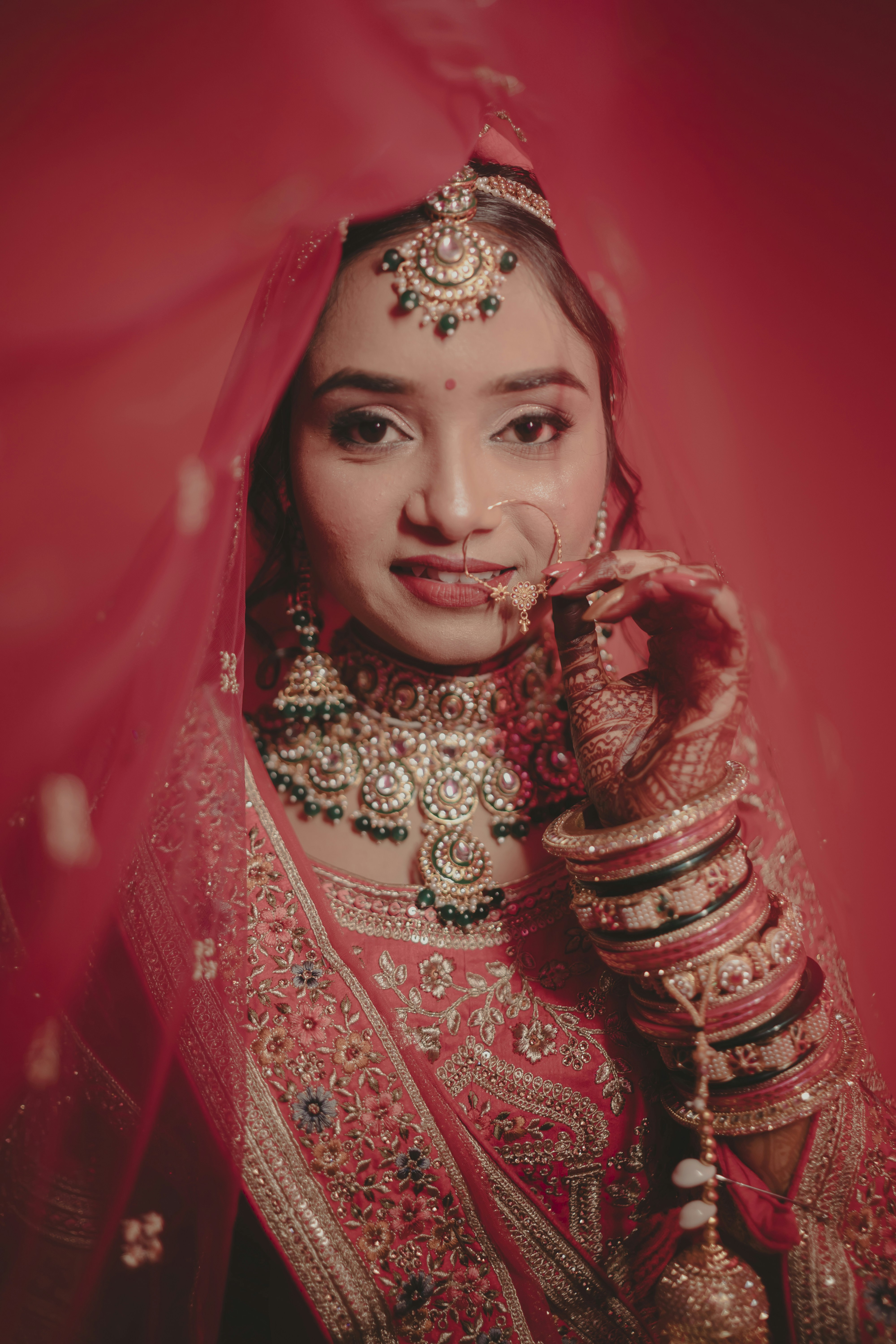 A woman in a red and gold bridal outfit