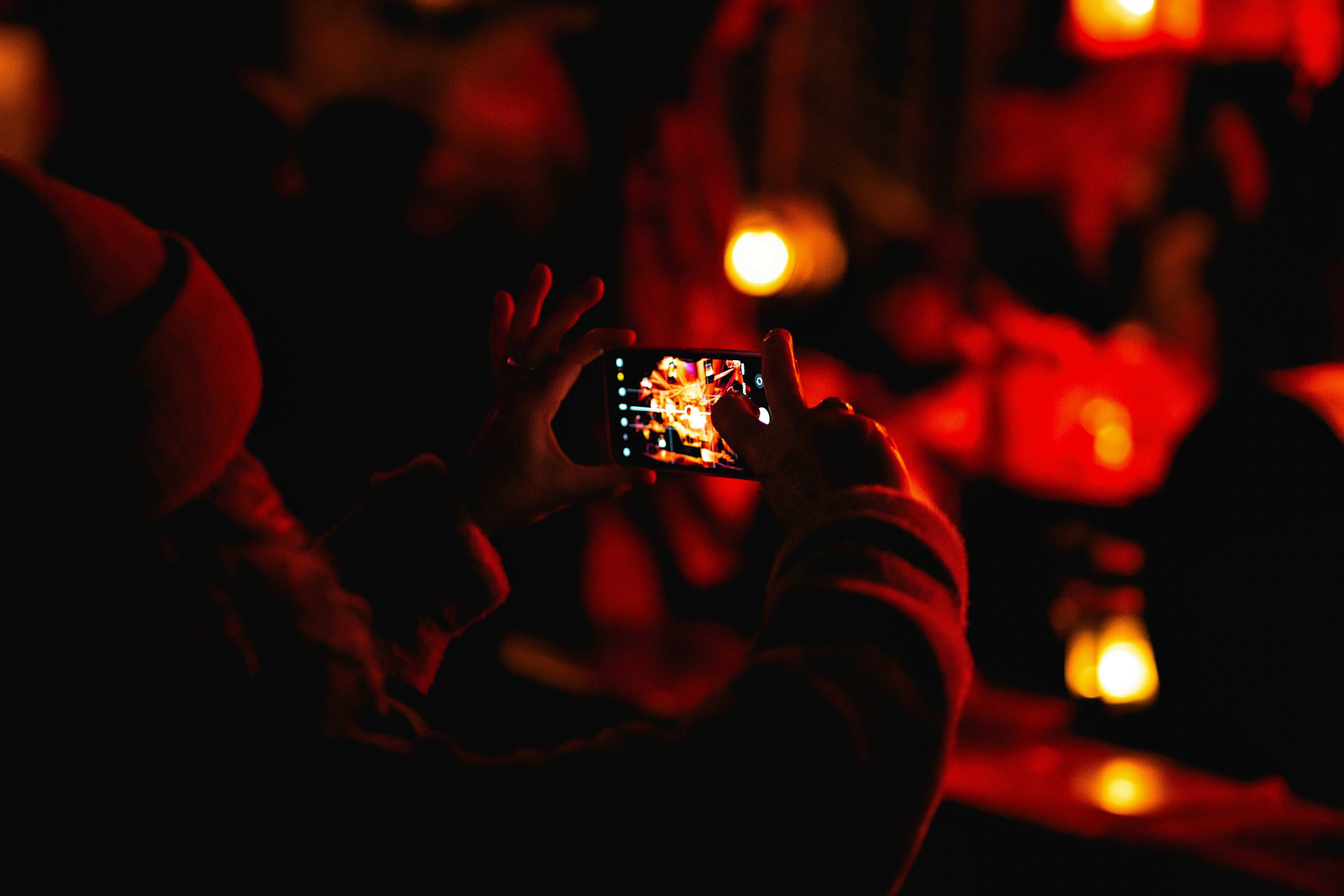 A person taking a picture with a cell phone