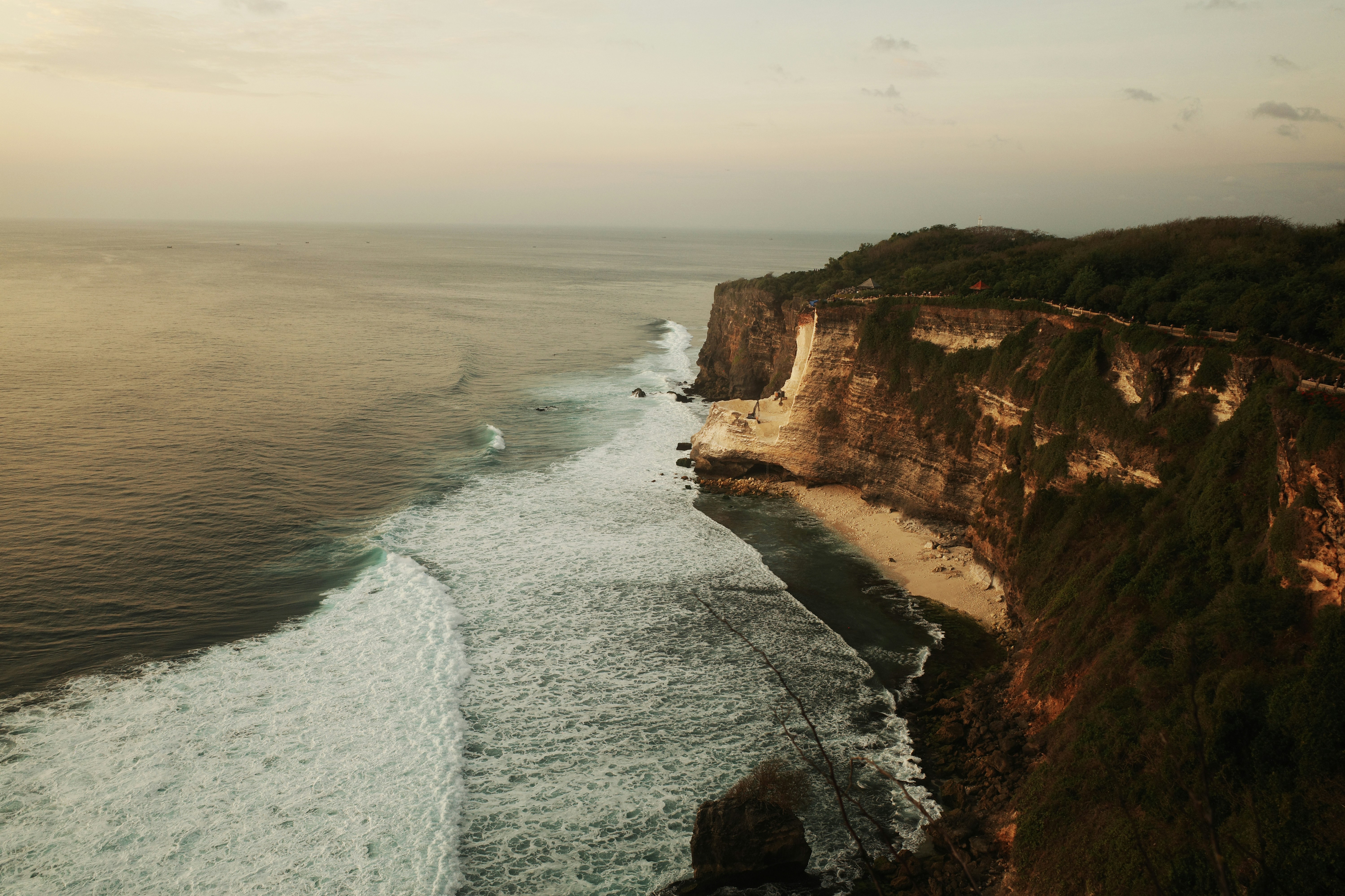 An aerial view of a cliff overlooking the ocean
