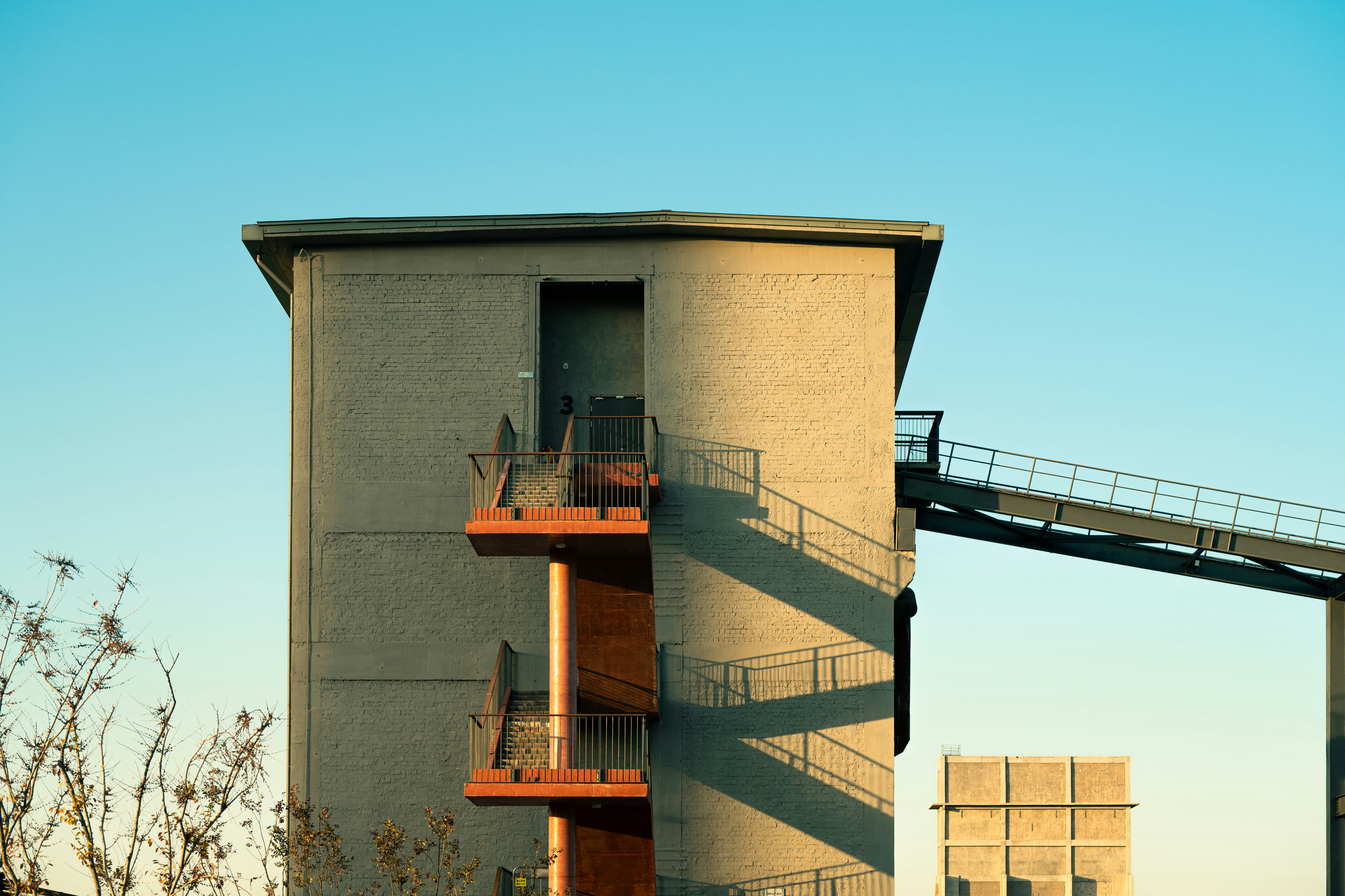 A tall building with a staircase going up the side of it