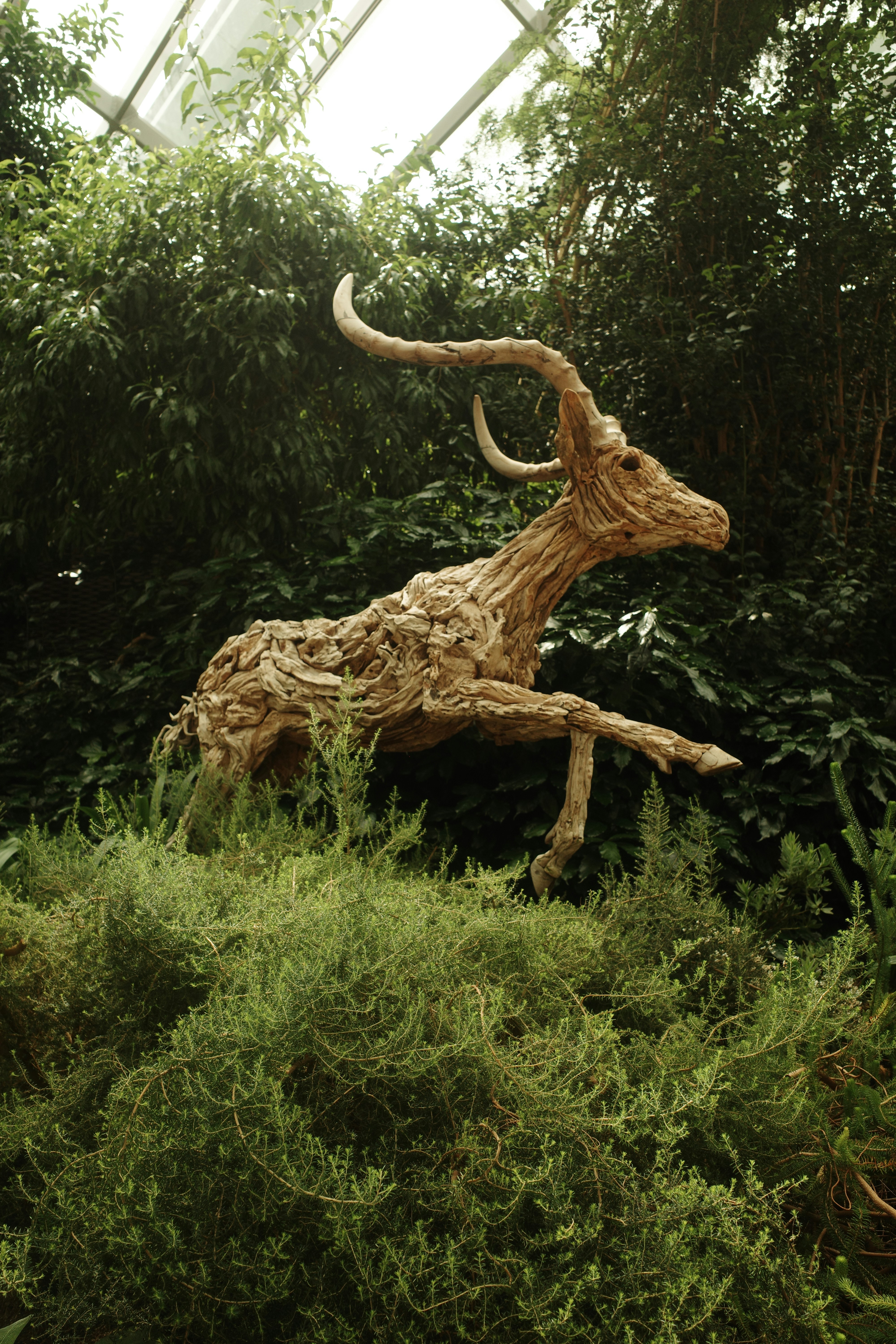 A sculpture of an animal running through a forest