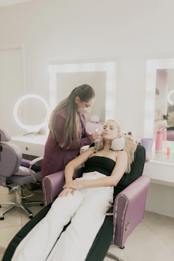 A woman sitting in a chair getting her hair done