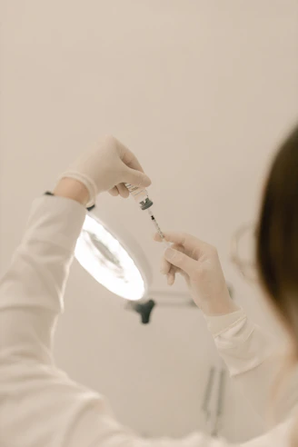 A woman in a white sweater brushing her teeth