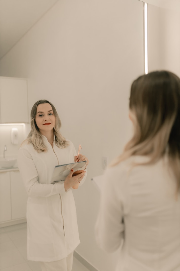 Dr. Isabelle Renard, Lead Aesthetic Physician at Lumière Medical Spa, reviewing patient notes