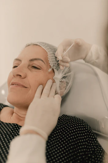 A woman getting her hair done by a hair stylist