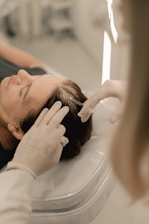 A woman getting her hair cut by a hair stylist