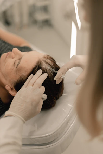 A woman getting her hair cut by a hair stylist