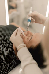 A woman getting her teeth checked by a doctor