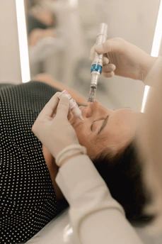 A woman getting her teeth checked by a doctor