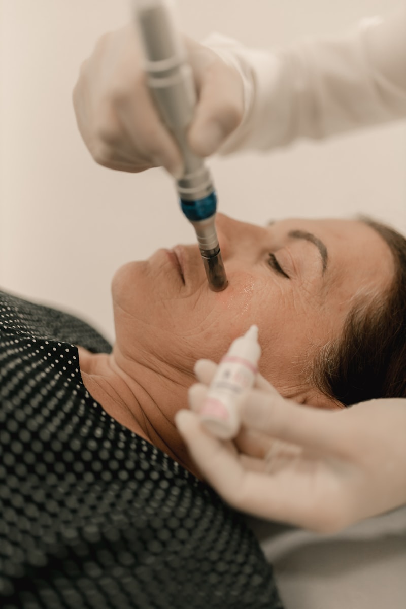Doctor treating a patient's face during a dermatology or skin procedure