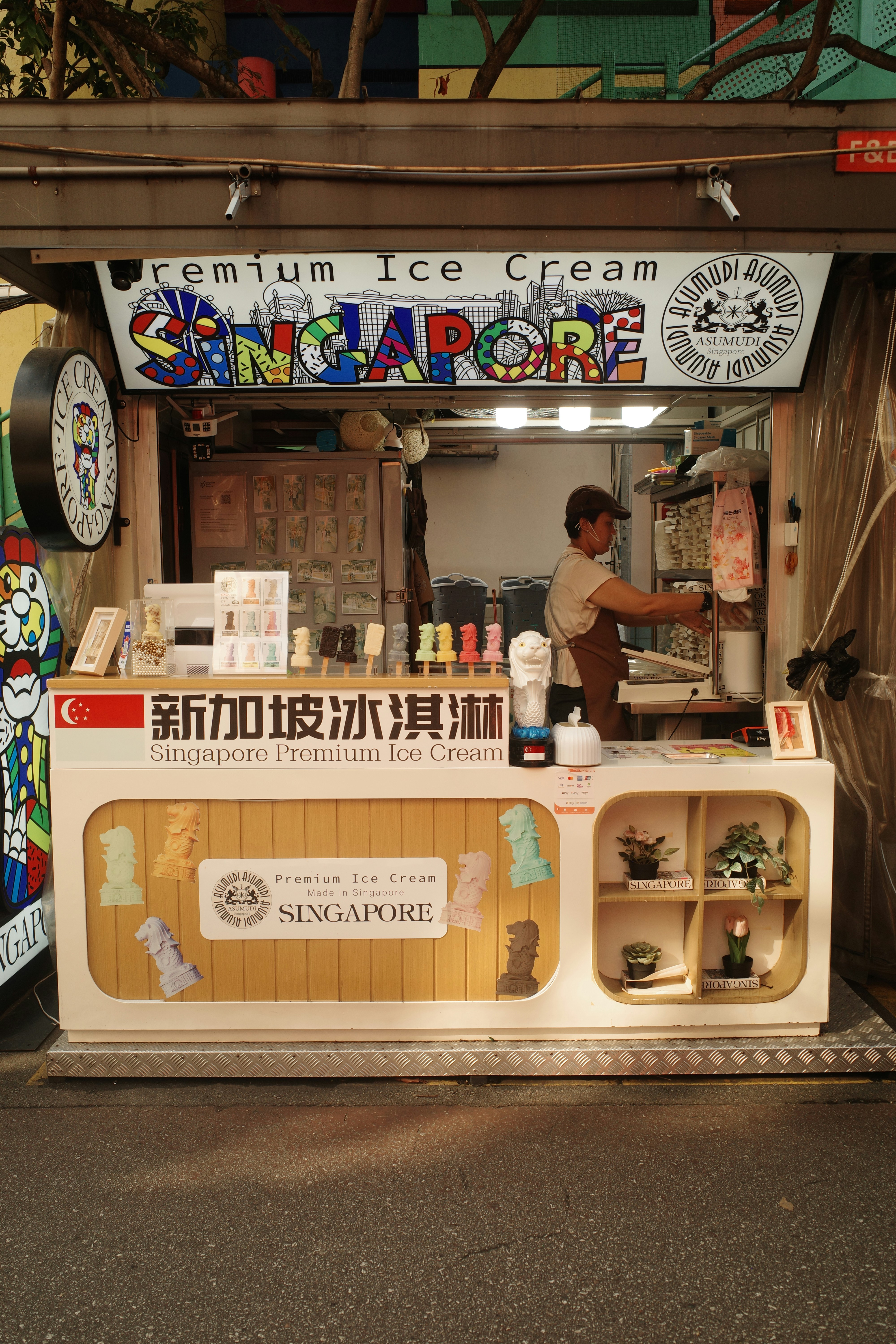 A food stand with a man cooking food inside of it