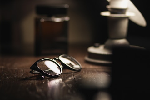 A pair of glasses sitting on top of a wooden table