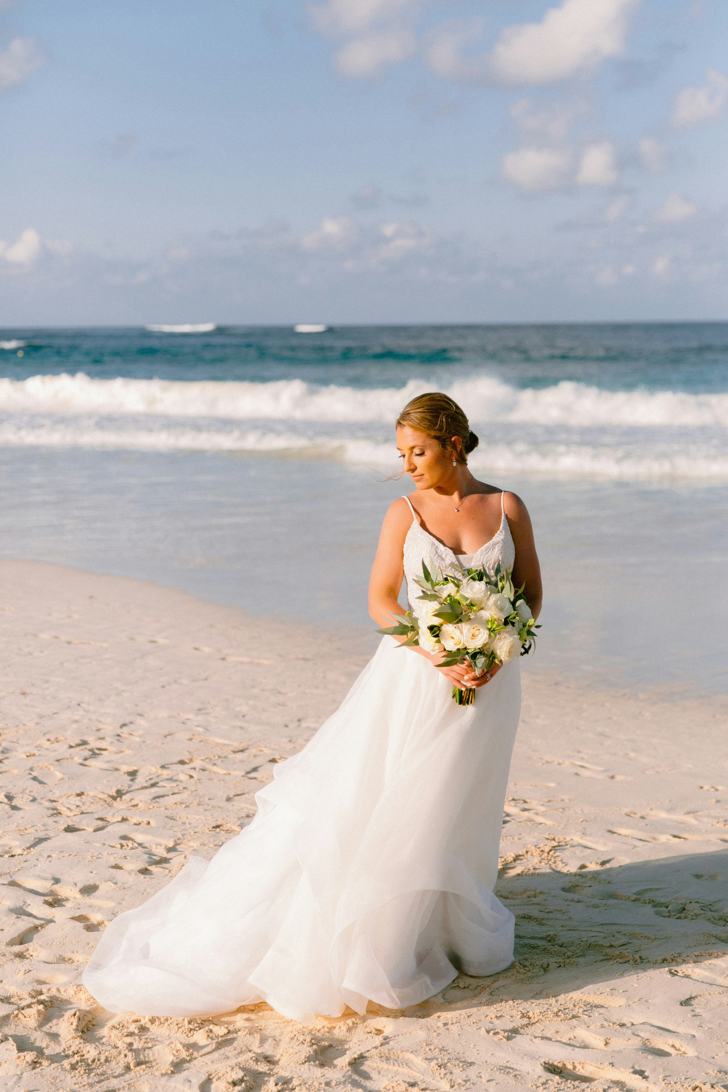A woman standing on top of a sandy beach