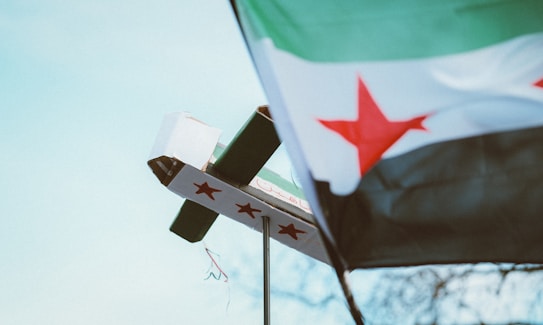 A flag and a cross on a pole