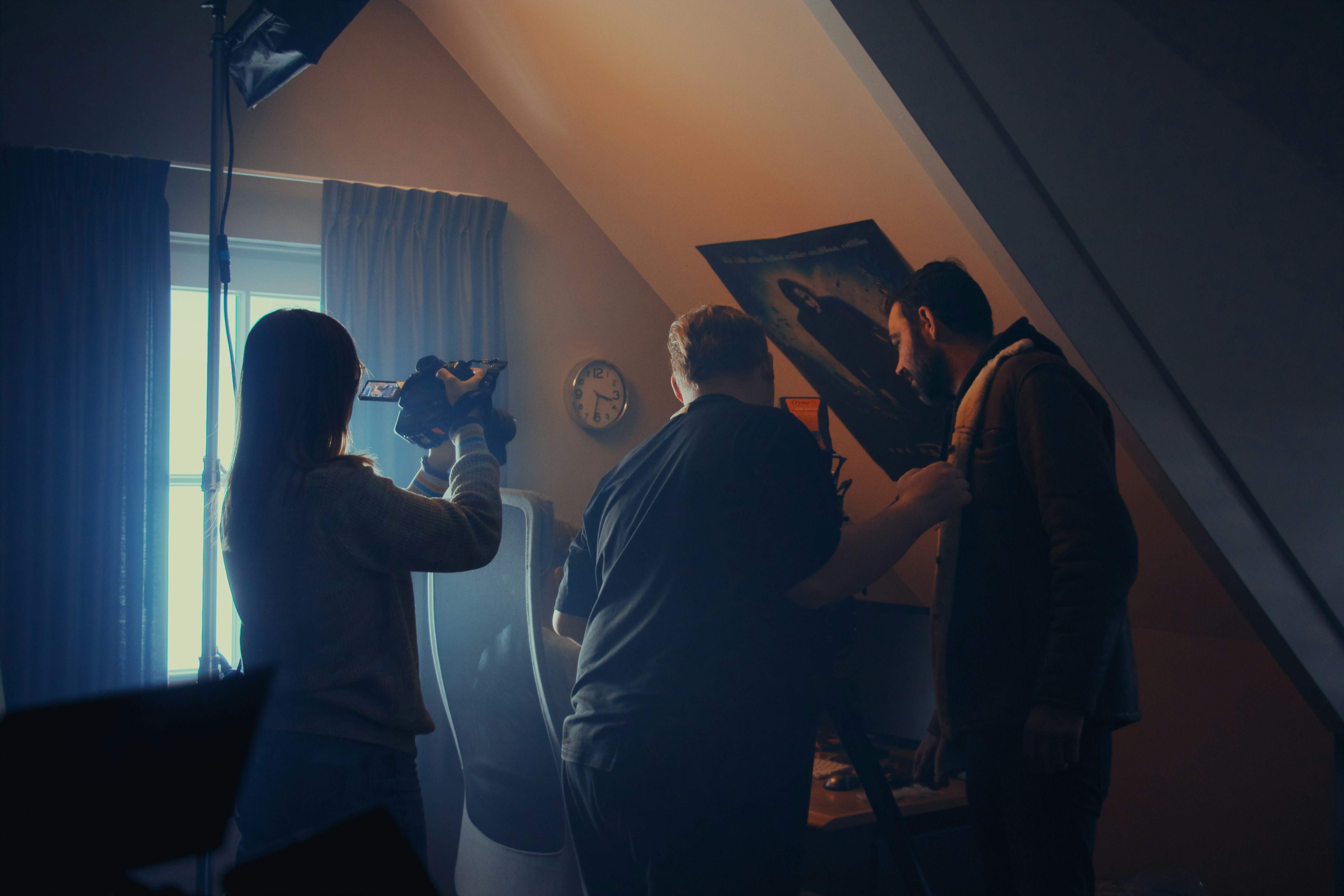 A group of people standing around in a room