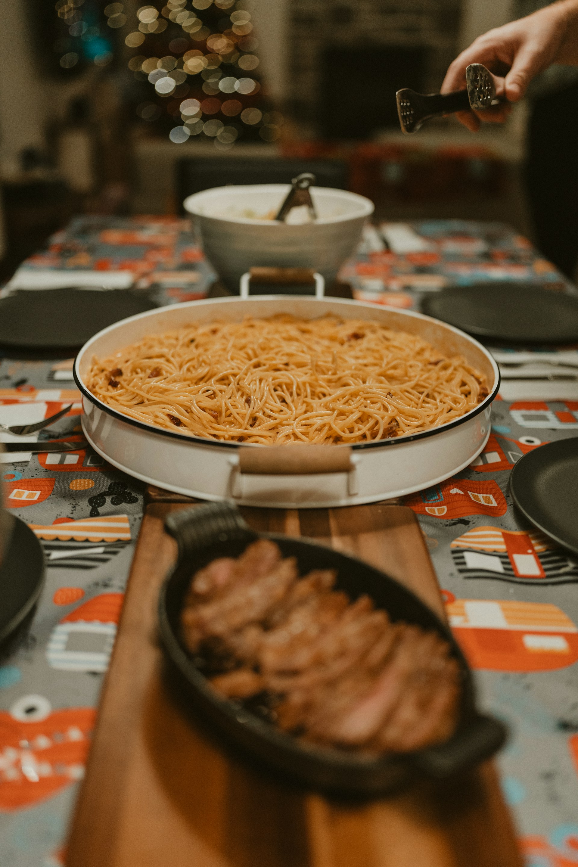 A table topped with plates and bowls of food