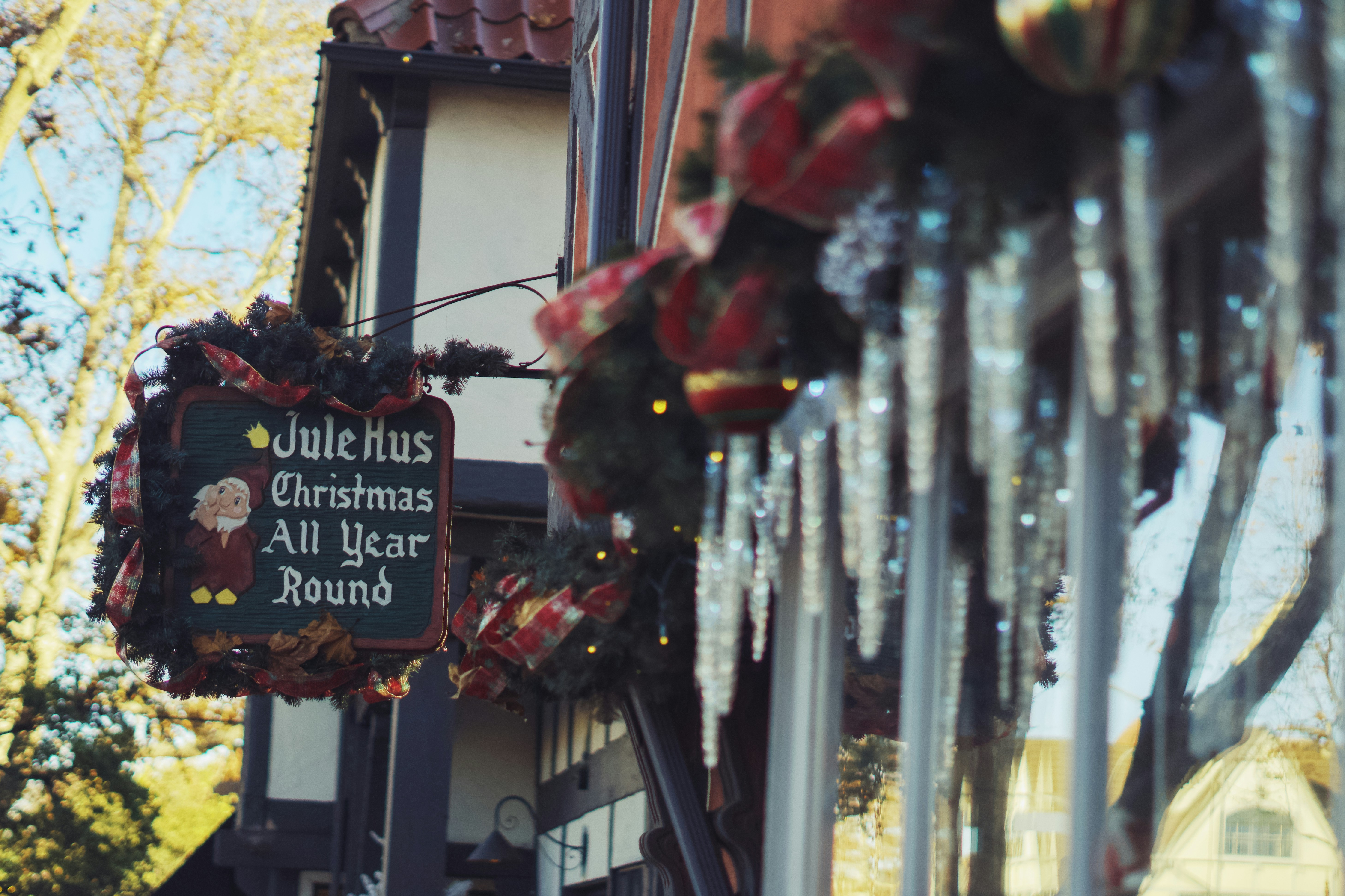 Un frente de tienda con adornos navideños colgando de un lado