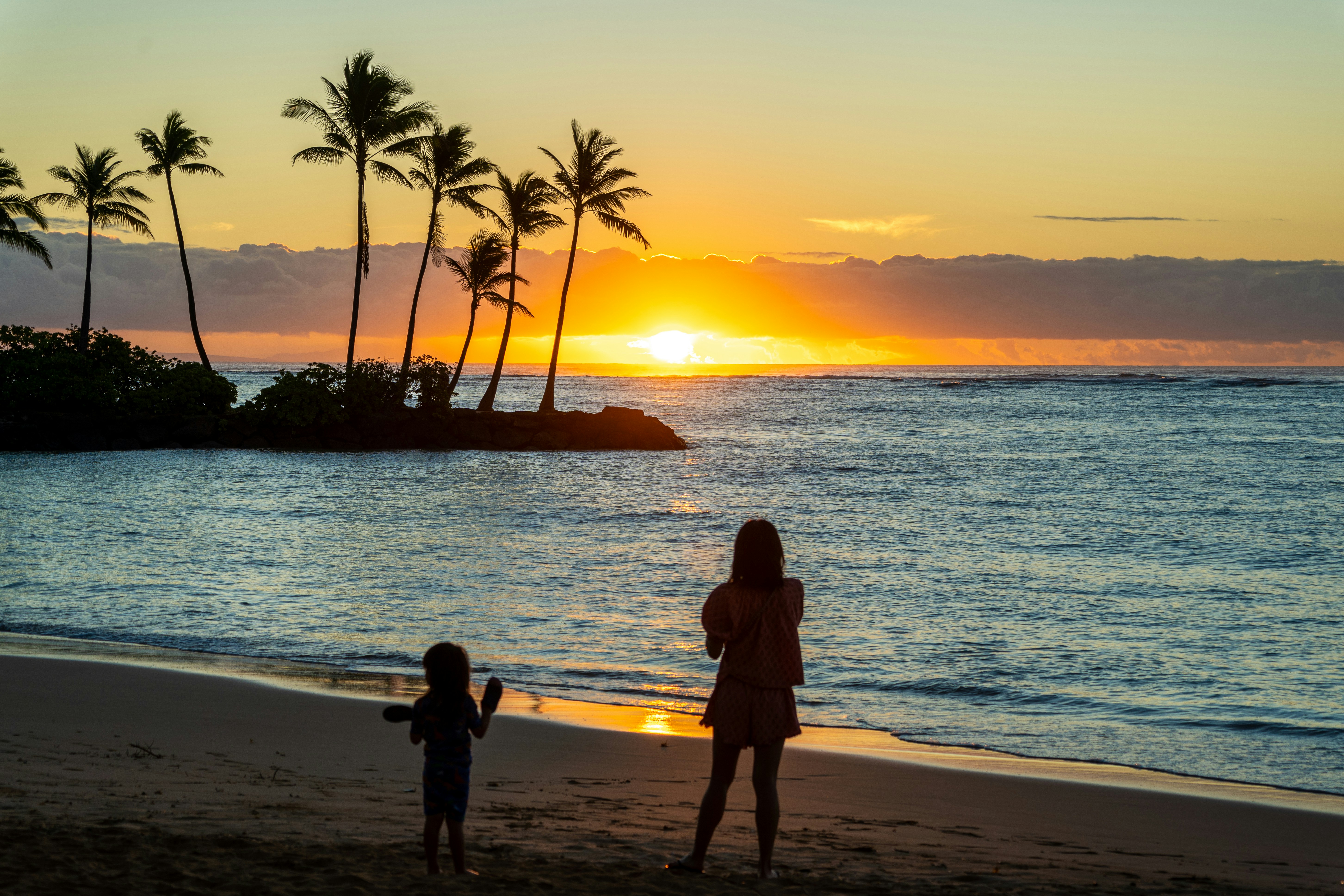 Family planning a vacation itinerary on Maui's beach