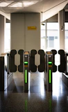 A row of turns at an airport with green lights