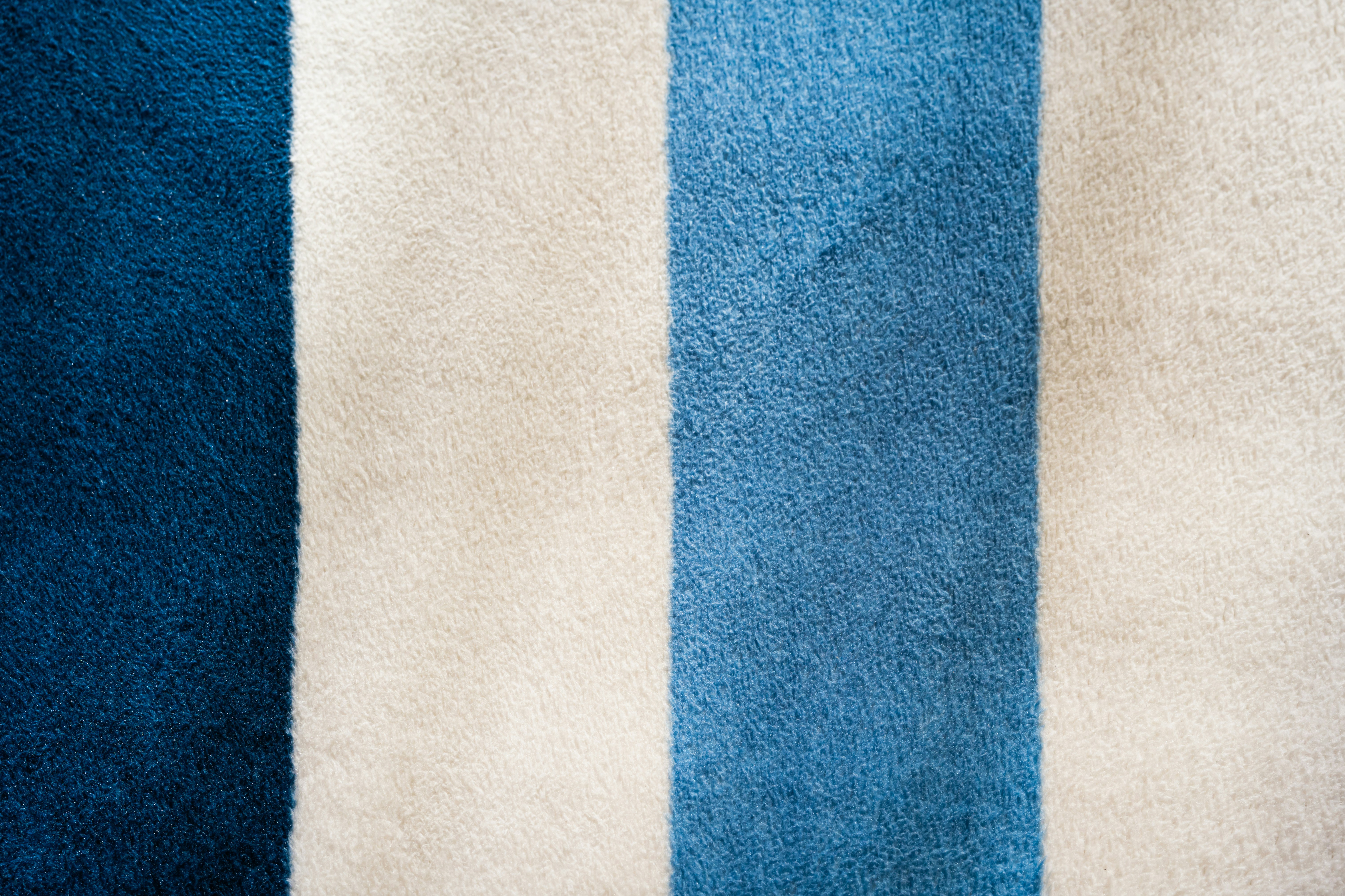 A close up of a blue and white striped rug