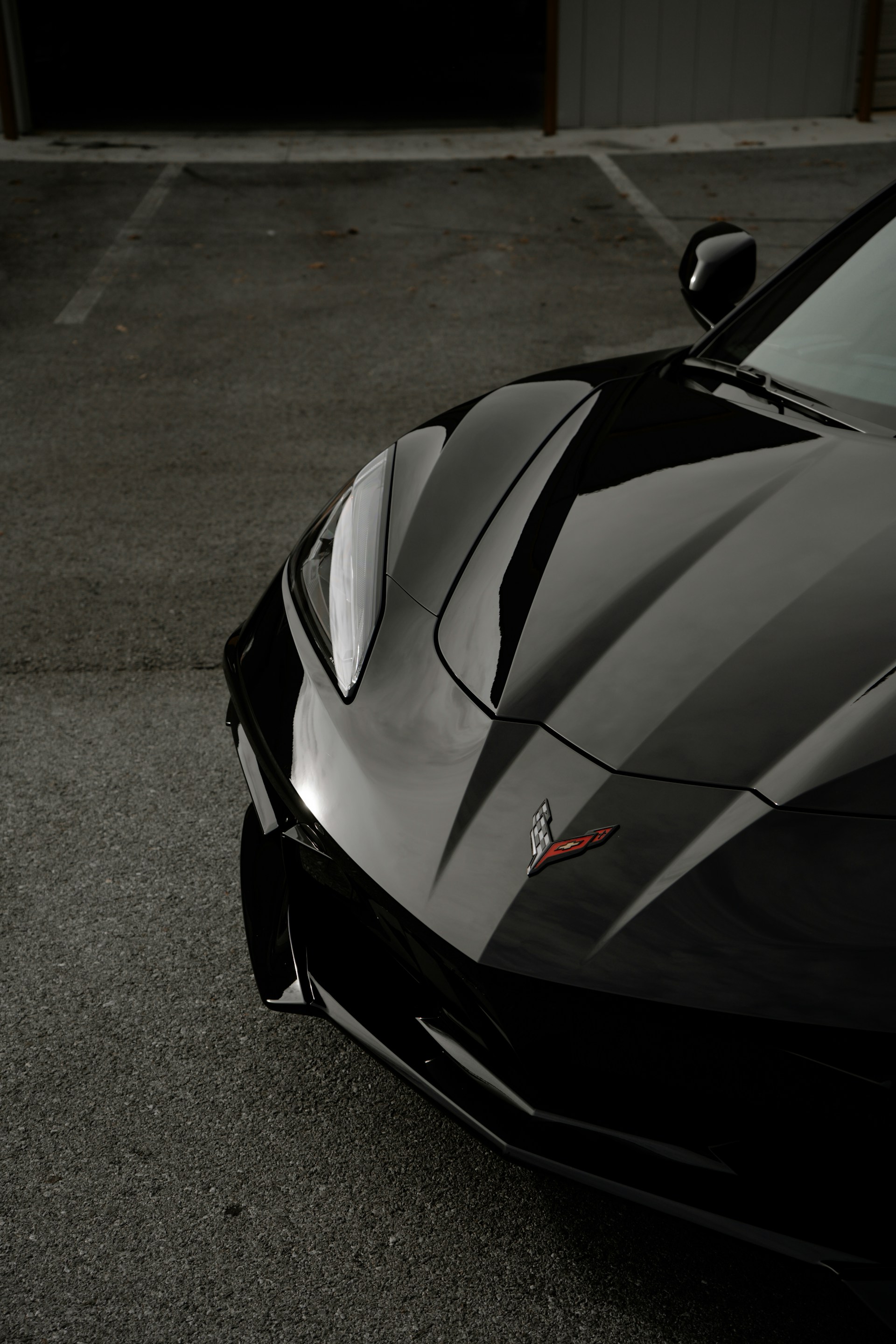 A black sports car parked in a parking lot