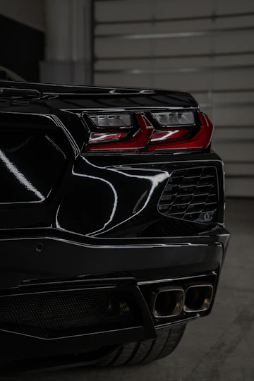 A black sports car parked in a garage