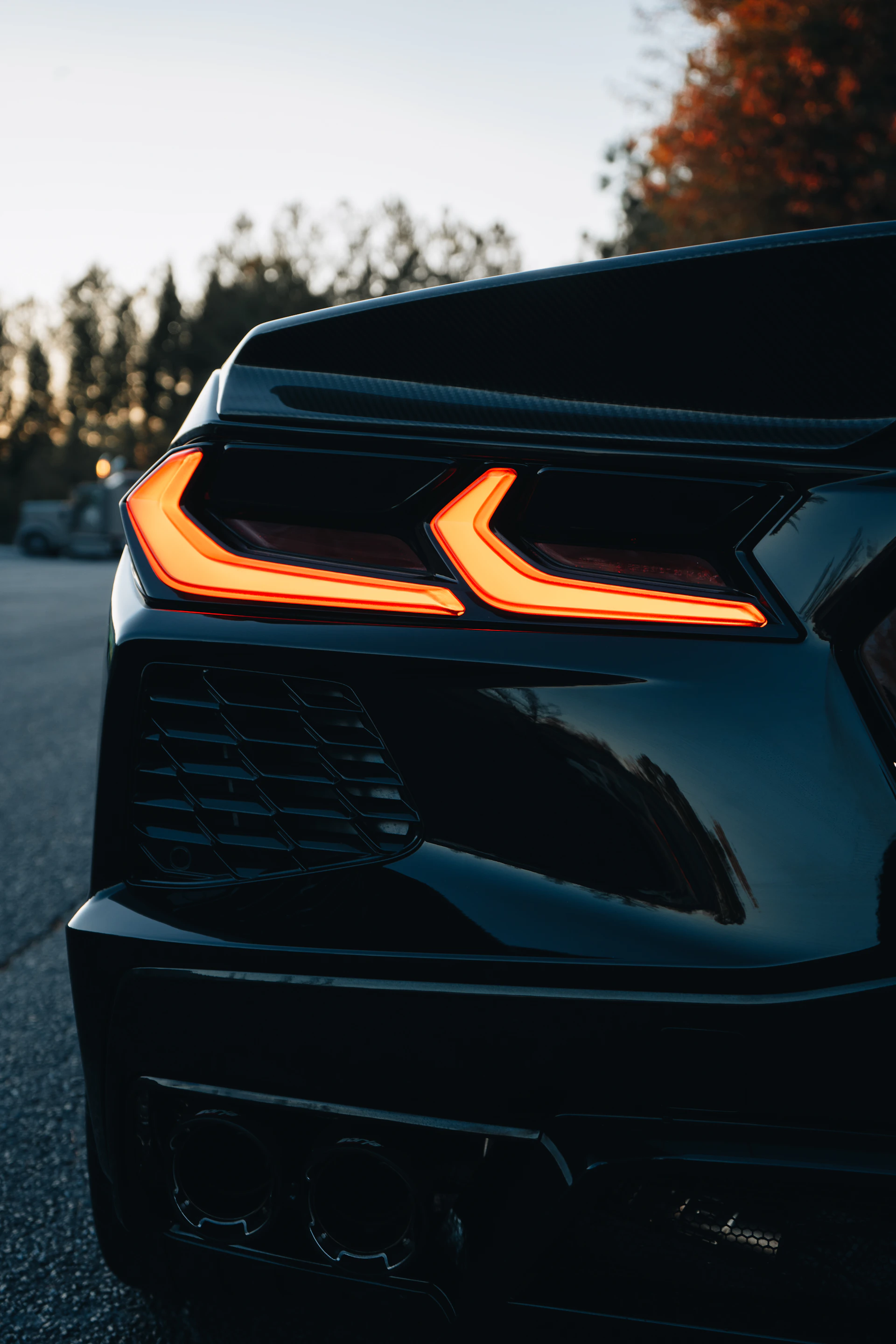 A close up of the front of a black sports car